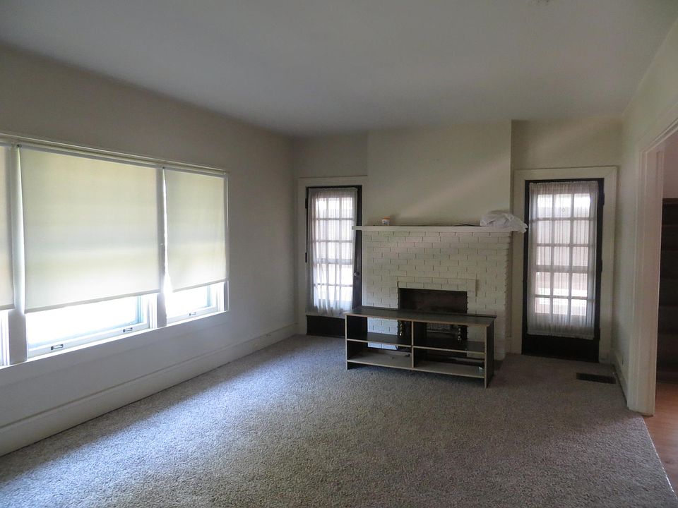 living room with enclosed sunroom outside of those 2 doors. 