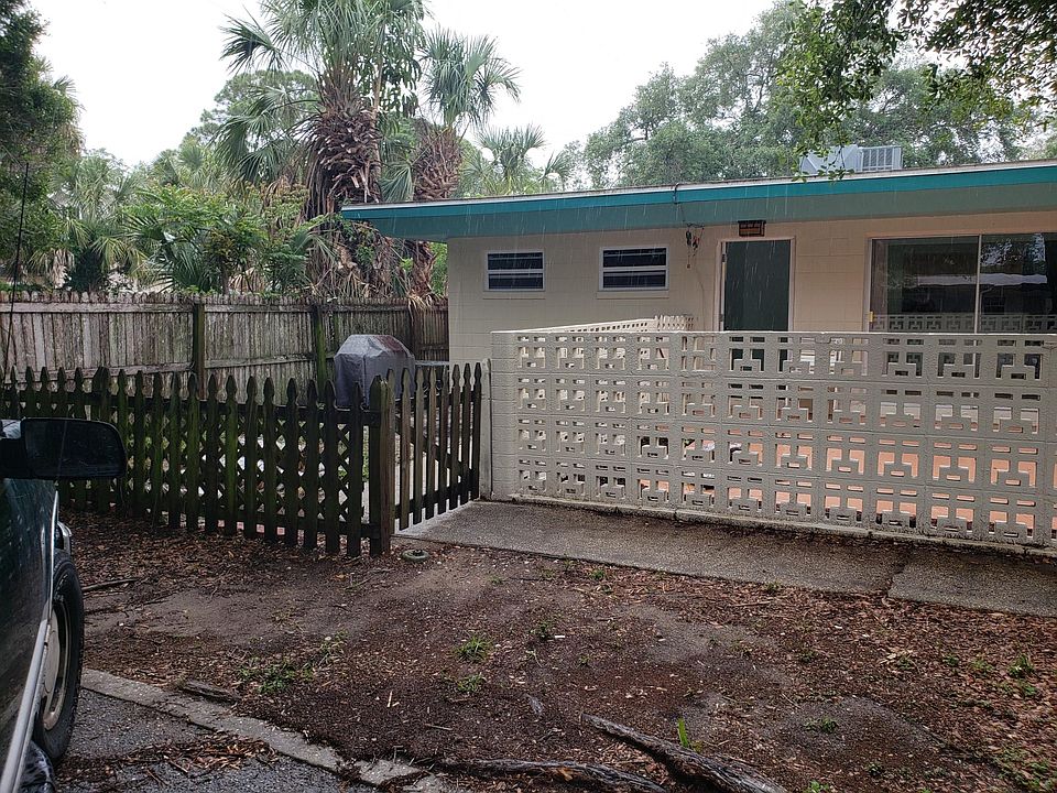 Front of unit with small private yard and fenced patio.