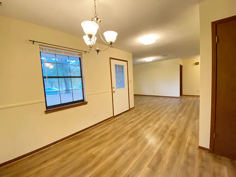 view from dining room looking toward front door and living room