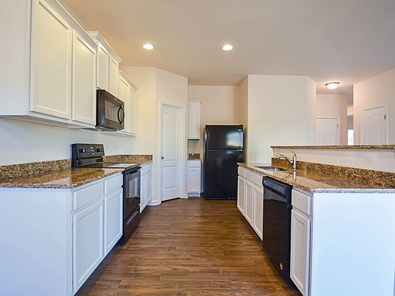Kitchen comes complete with granite counters and energy efficient appliances