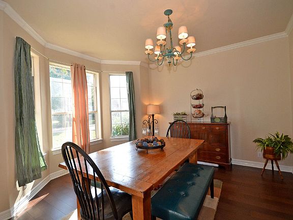 A bay window accents this spacious dining room.