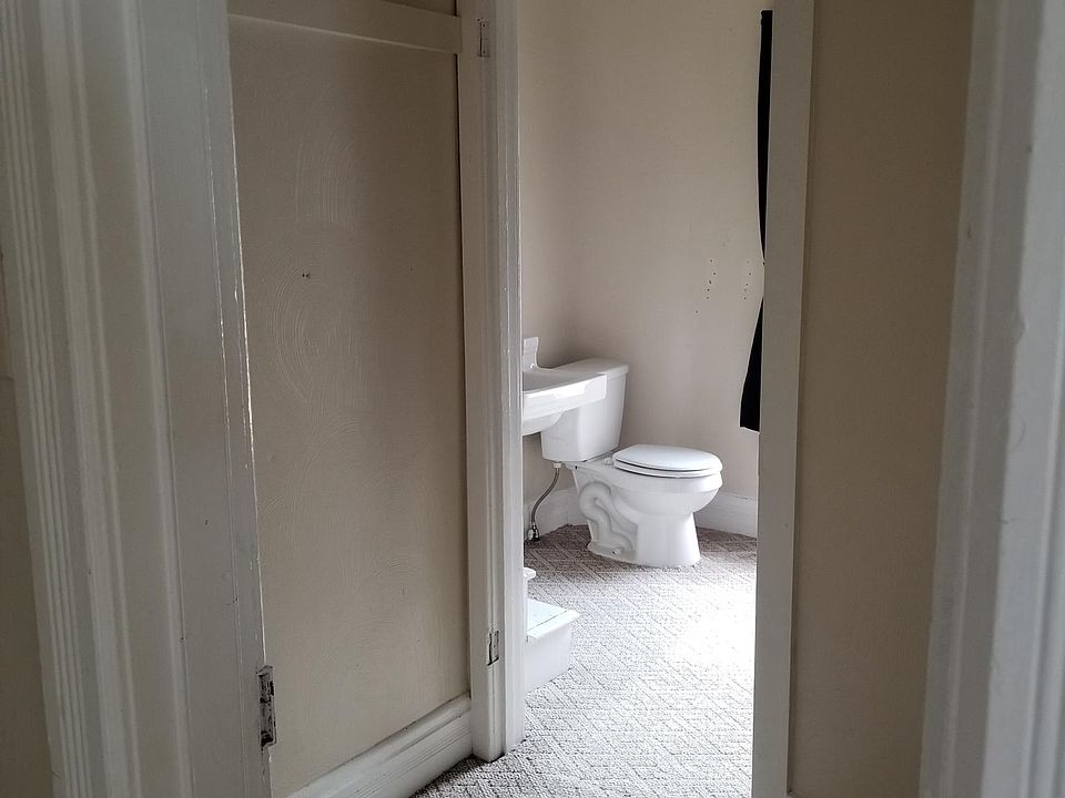 Additional closet space leading into bathroom.