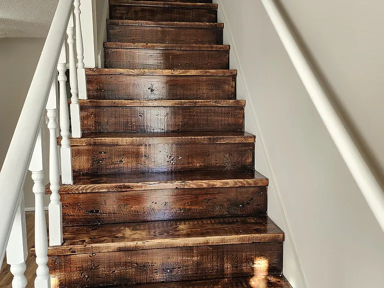 View of stairs-natural wood look matching and enhancing other flooring of the property.