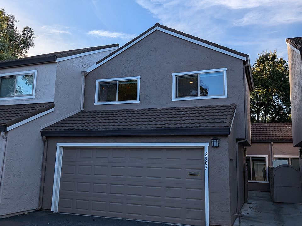 Front view showing 2-car garage and the walkway entrance to main door