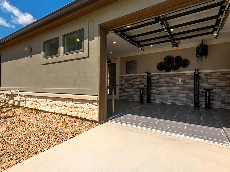 On-Site Bicycle Repair Shop With Open Garage Door Access