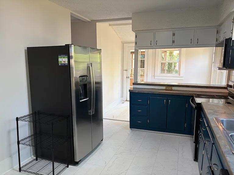 New fridge. Kitchen Looks out to the light and bright dining nook.