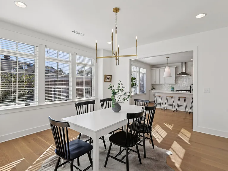 Dining area with oversized windows and open flow into the kitchen.