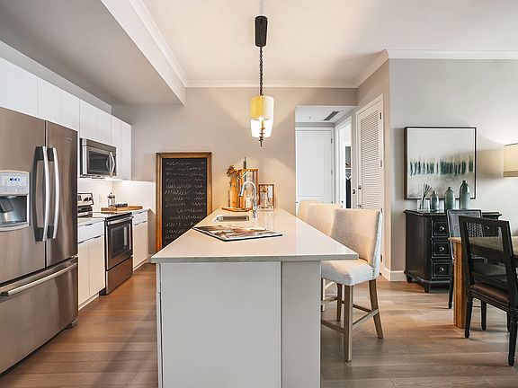A chef-inspired kitchen featuring granite countertops, stainless steel appliances, and a spacious island for gathering