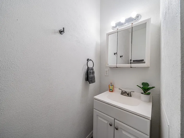 A clean and modern vanity with ample storage and bright lighting.