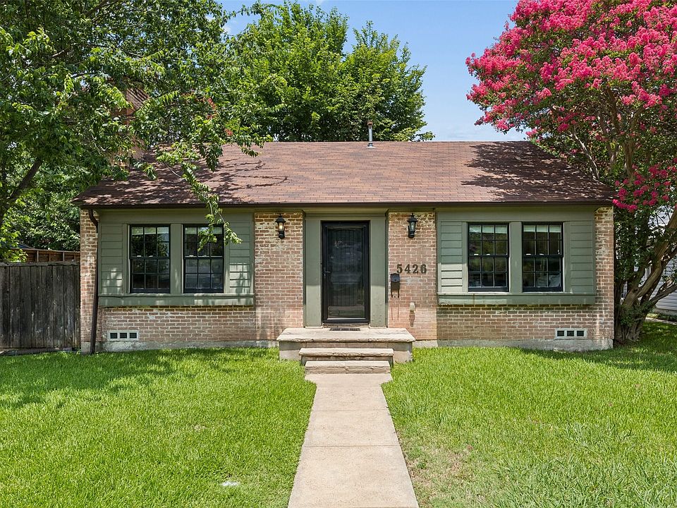 Brick and siding exterior with a brown shingle roof