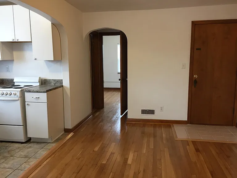 Dining area and short hallway leading to bathroom and bedroom Rear hallway door is on the right.