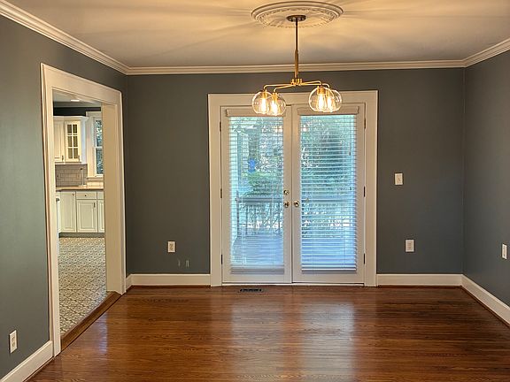 Dining room, with French doors to the fenced backyard.