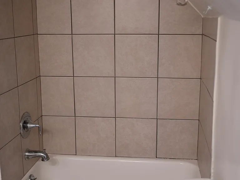 Bath tub/shower with new ceramic tile