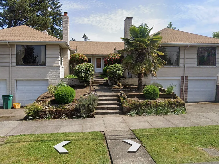 Front view of four-plex. Unit in the front on the right. Unit has a main level along with an unfinished basement space with washer / dryer and access to the garage.
