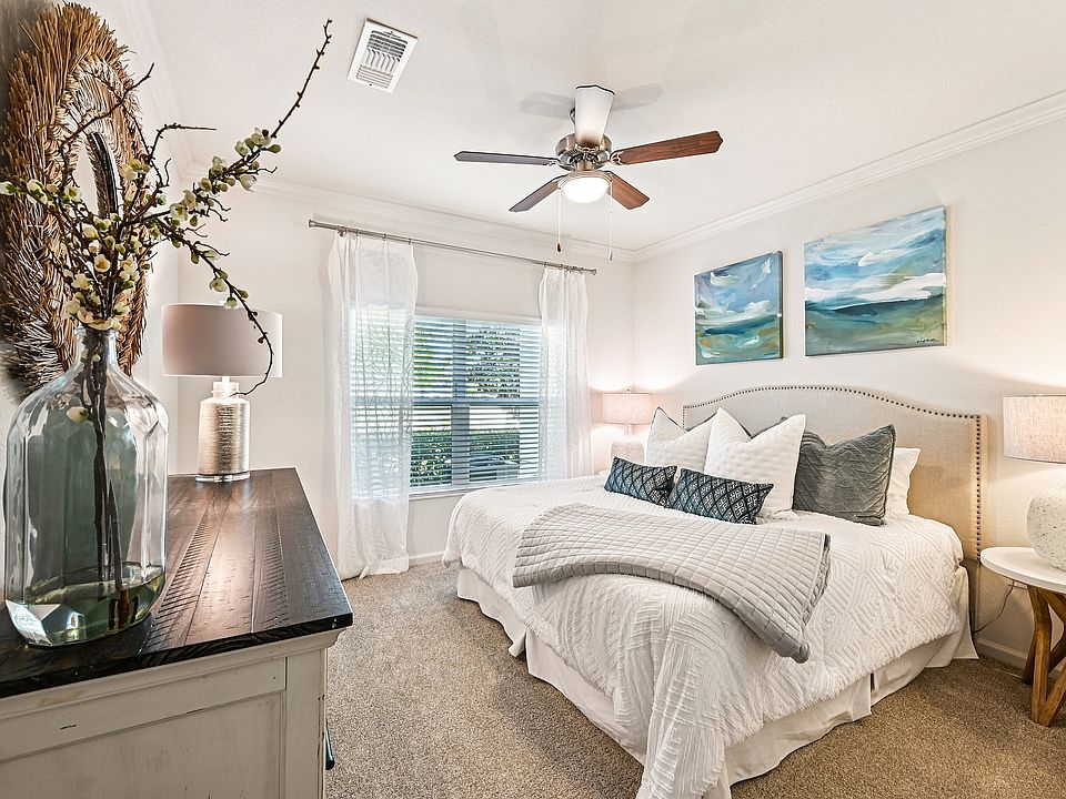 Elegant bedroom featuring a cozy king-sized bed, soft lighting, and tasteful artwork. Natural light flows through large windows, highlighting the serene and stylish decor.