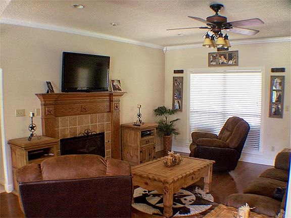 Family room has a wood burning fireplace for the cool evenings.