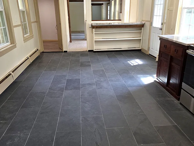 Looking across slate floor to dining area. Bonus room is in the back left.