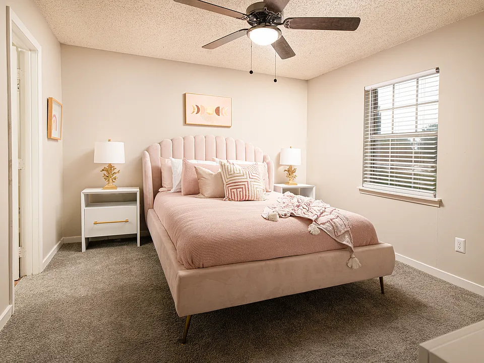Stay comfortable year-round in this stylish bedroom with a ceiling fan at Southwind Apartments in Richland, MS!