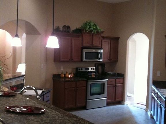 Kitchen with tile floors & stainless steel appliances