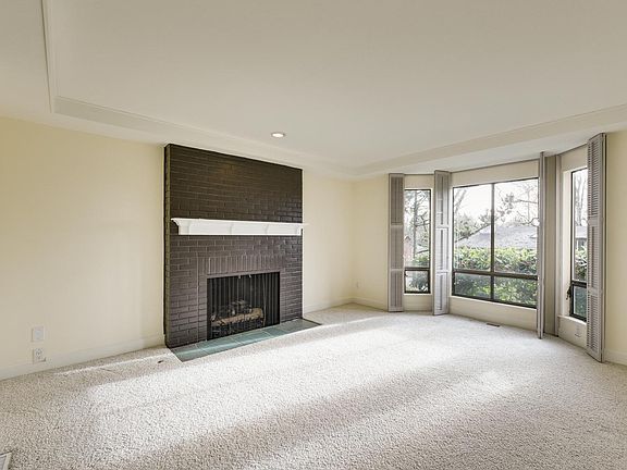 Living room with fireplace and large south-facing windows