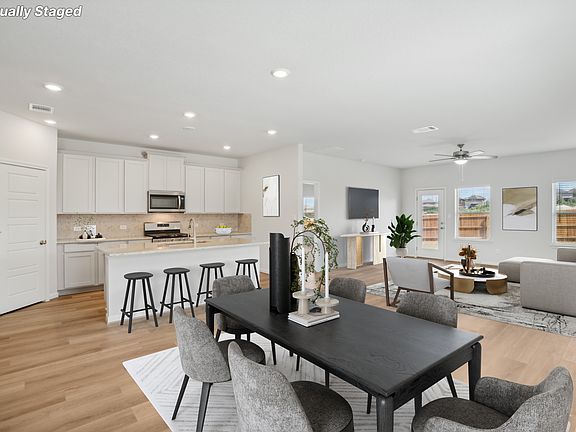 Virtually staged dining and living room in the Reynolds floorplan at a Meritage Homes community.