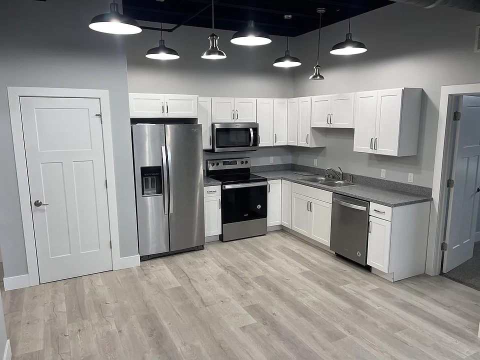Kitchen with dish washer, refrigerator and microwave.
