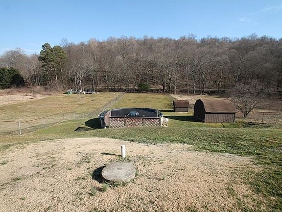 back yard with fence, pool and two sheds