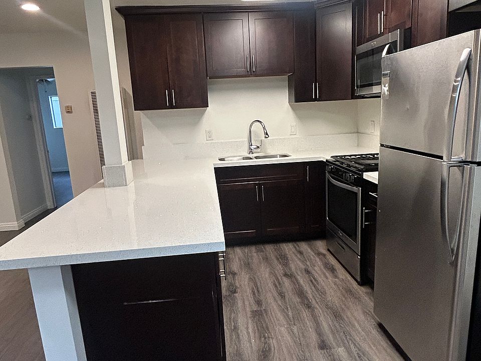 Fully upgraded gourmet kitchen with quartz countertops and stainless steel appliances