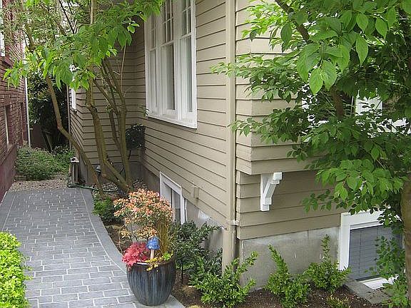 Pathway leads to hose for easy watering or car washing.