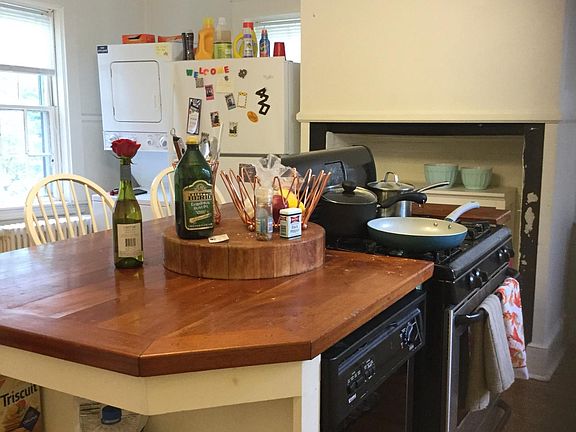 Kitchen Island with dishwasher and gas stove, Washer dryer and refrigerator in rear