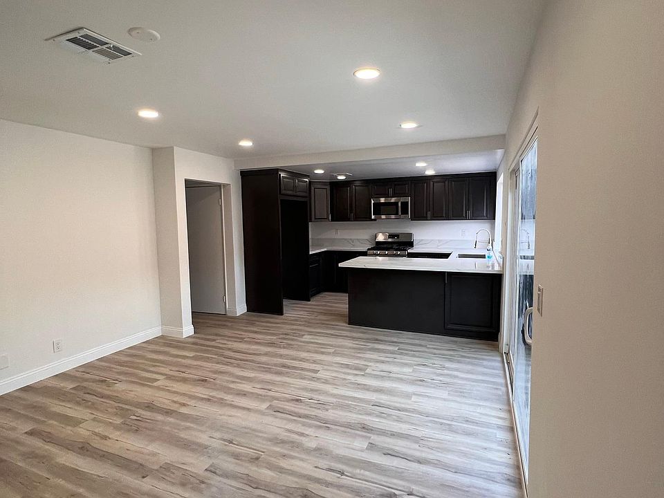 Family /TV room next to kitchen with sliding patio door going to patio and garage.