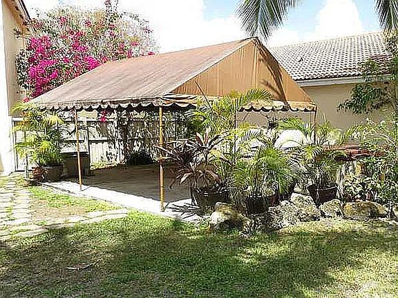 Side of house.  Large tent.