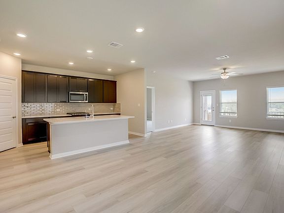 The open-concept kitchen, living, and dining areas makes this house feel extra spacious.