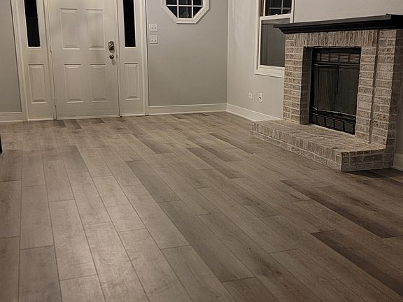 Entrance into condo with new flooring, painting, lighting, and soon to be windows