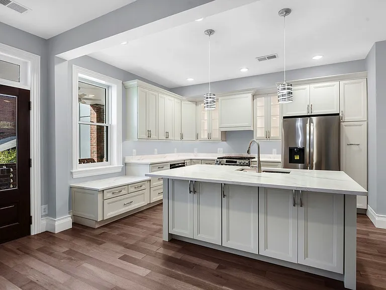 kitchen showing additional base cabinets for storage under the island