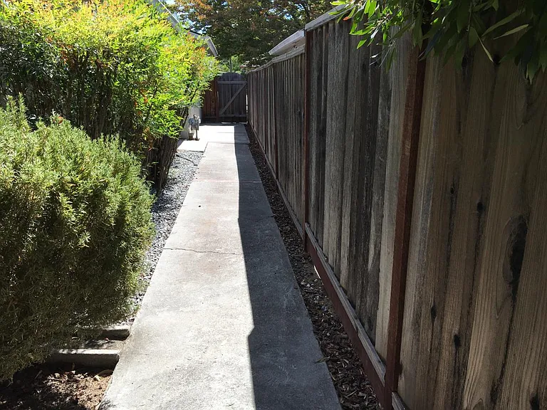 Side yard, leads to the front yard and a service door to the