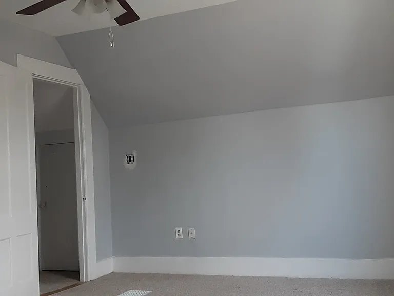 Bedroom with ceiling fan. Bedrooms are on third floor.