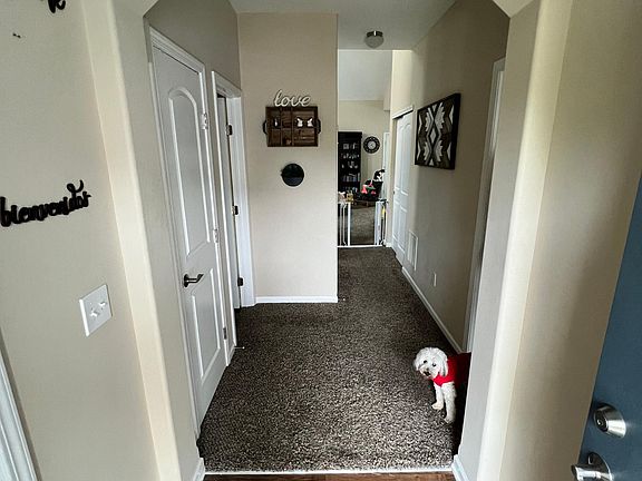 coat closet and half bathroom door on left, owner suite door on right
