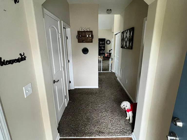coat closet and half bathroom door on left, owner suite door on right