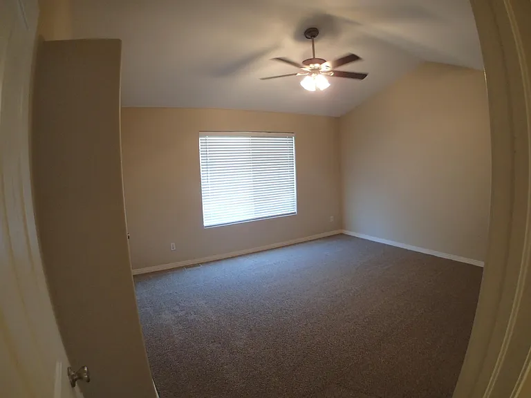 Master with ceiling fan and vaulted ceilings