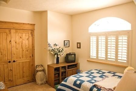 Guest bedroom and closet with solid alder wood doors