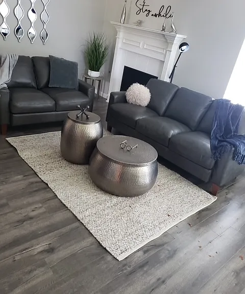 Enjoy a large living area with a fireplace and ceiling fan.