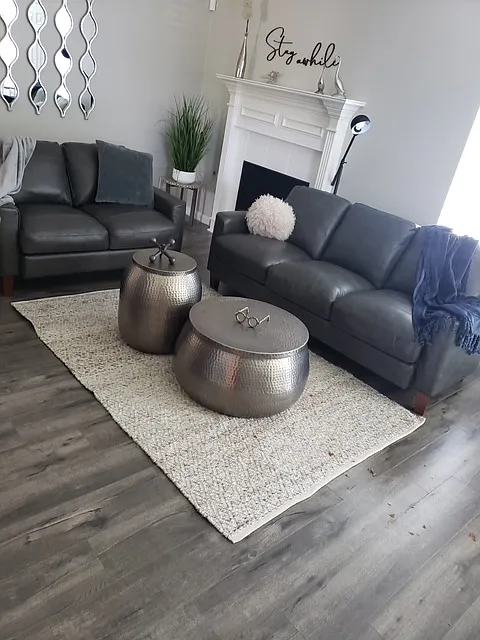 Enjoy a large living area with a fireplace and ceiling fan. - 7222 Wade Rd