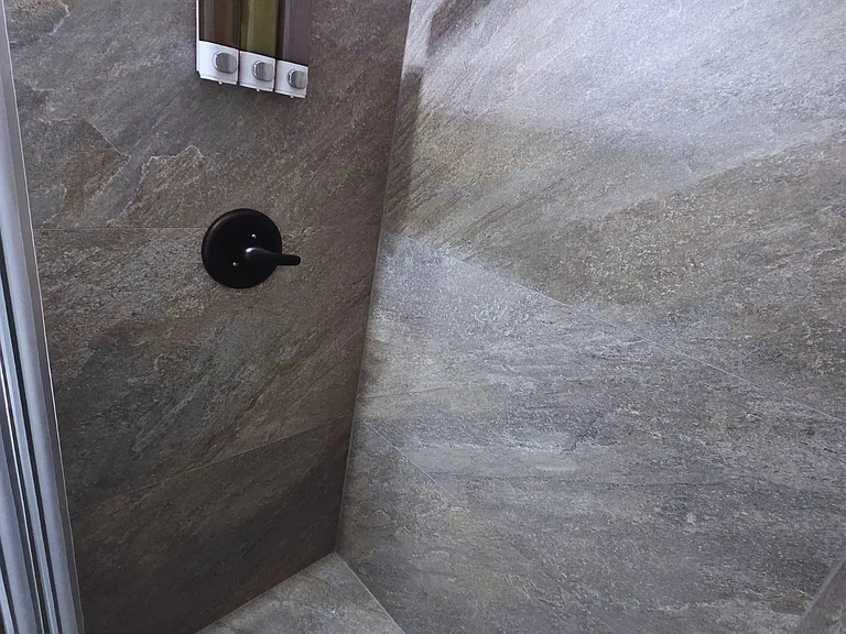 Contemporary shower with beautiful tile, liquid soap and shampoo provided.