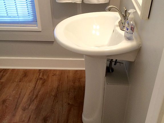 pedestal sink,wood floor