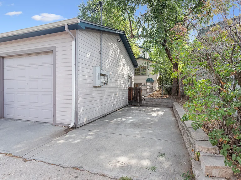Private entrance with 1 1/2 car garage and 1 uncovered space.