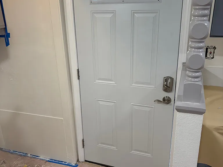 Back door, located in back of the kitchen and next door to washer/dryer hookups.