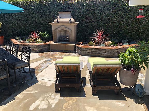 Gas fireplace - sitting wall and planter with drought tolerant plants.