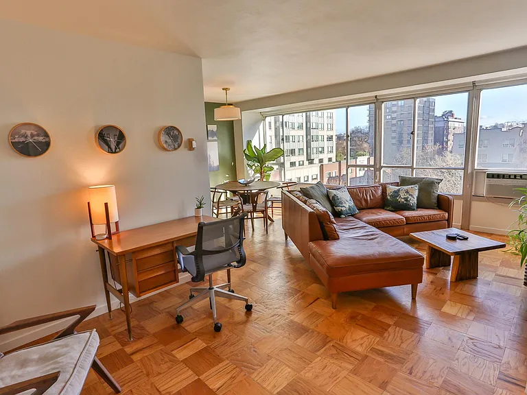 Open, bright, and cozy living area, with full height windows overlooking First Hill Park and the historic Stimson-Green mansion.