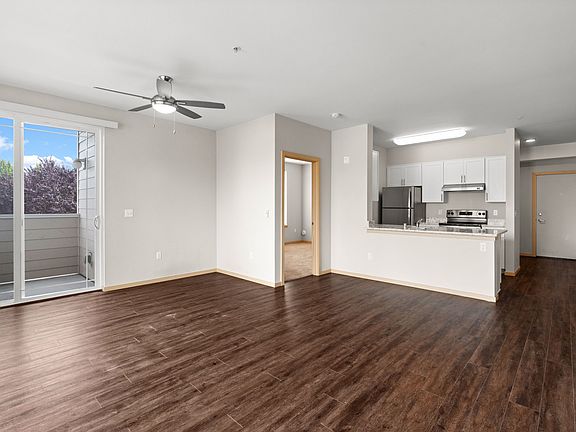 Open-concept living space with modern finishes and balcony access.
